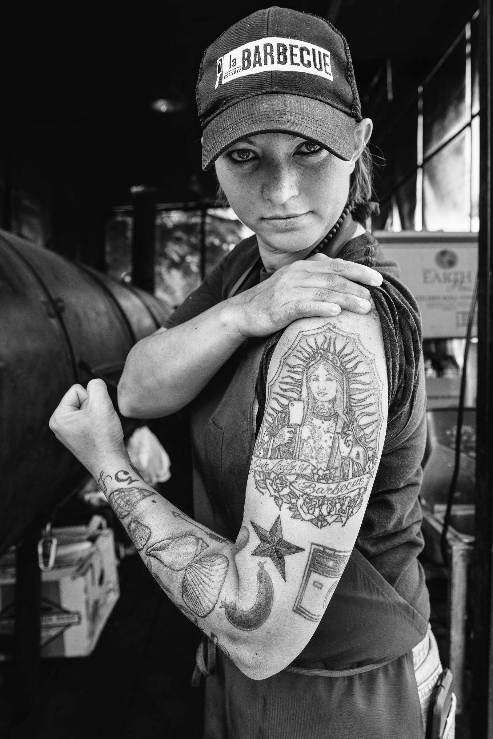 Portrait of Ali-Clem-Co-owner-LaBarbecue-Austin-TX -  displaying her arm tattoo.