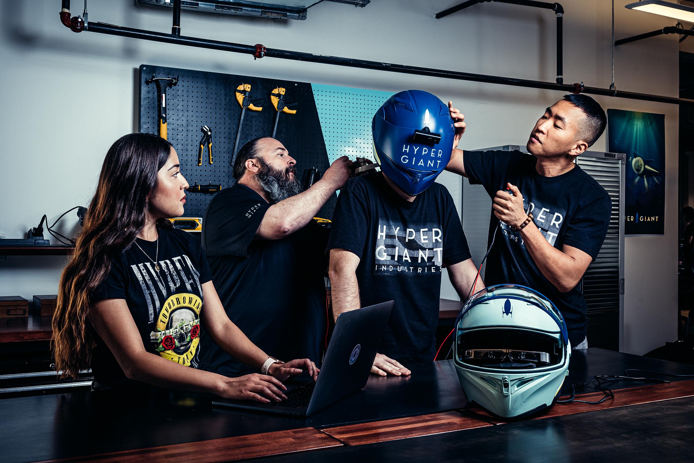 Corporate Lifestyle - Hypergiant AI Product Lab - Four colleagues work on a futuristic helmet 