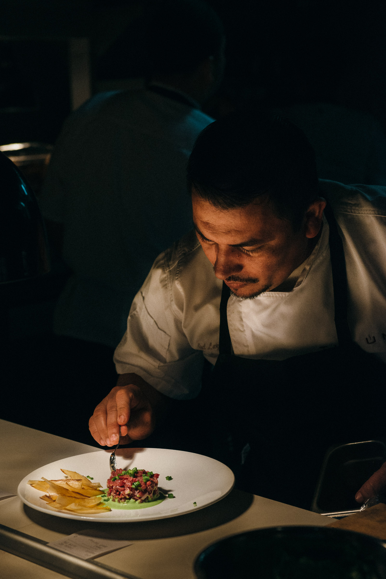 Line cook plating tuna tartare at Tulum restaurant in Dallas-TX