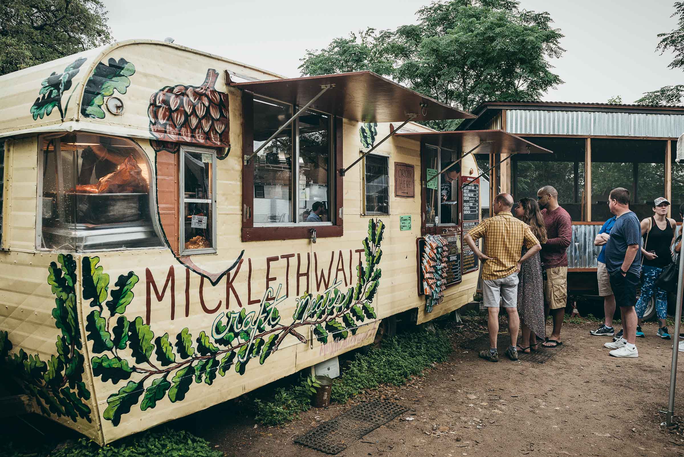  Mickelthwaites BBQ  trailer, with a line of hungry customers -East  Austin-TX.