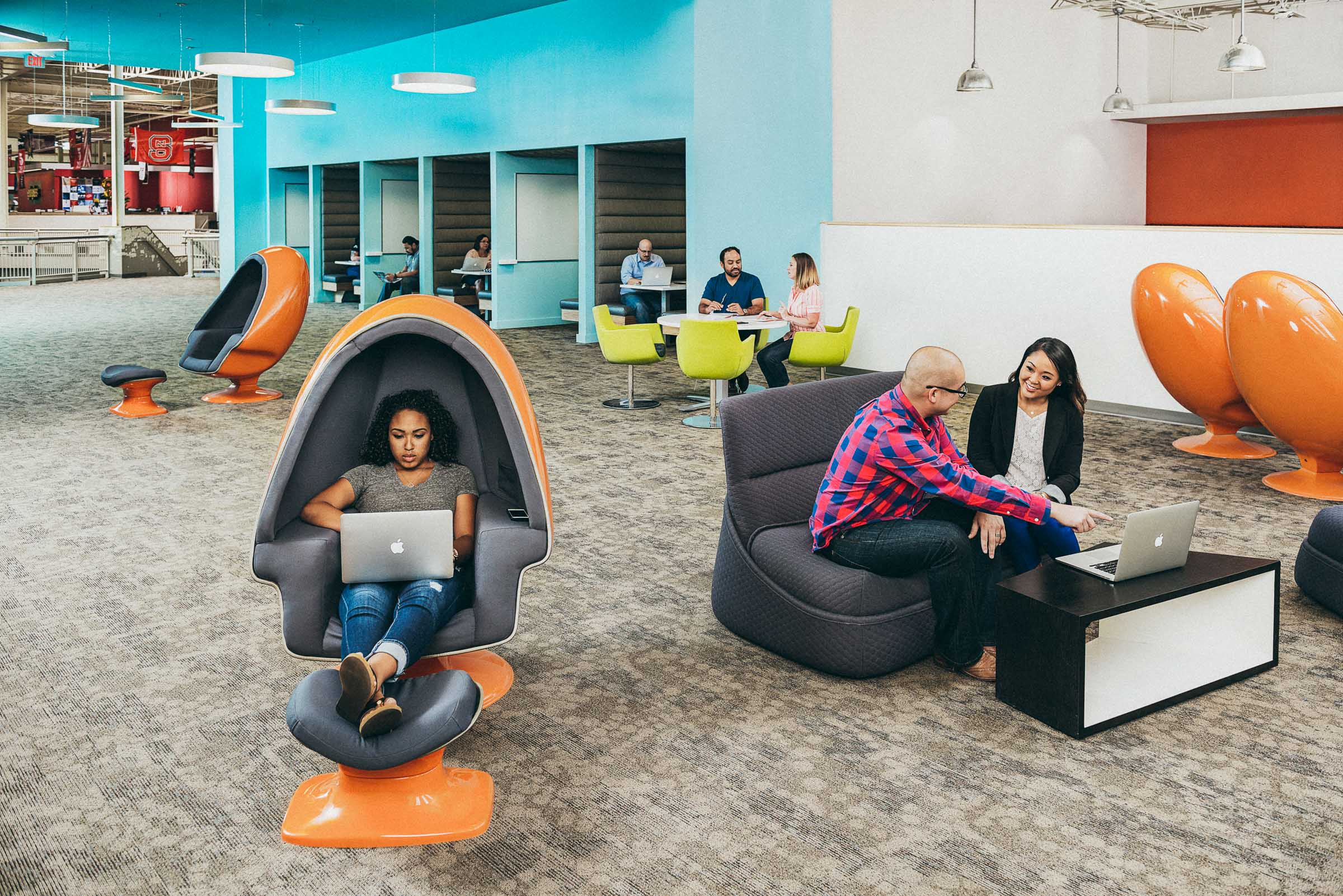 Corporate Lifestyle - Rackspace employees work in pods and modern booths.